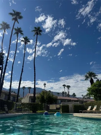 a view of a swimming pool with a yard