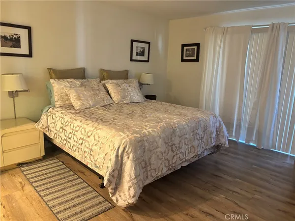 a large bed sitting in a bedroom next to a lamp