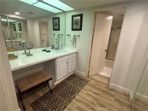 a spacious bathroom with a double vanity sink a mirror and a shower