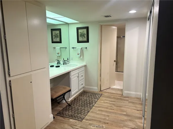 a bathroom with a sink a toilet and mirror