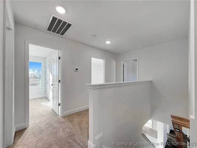 a view of an empty room and a window