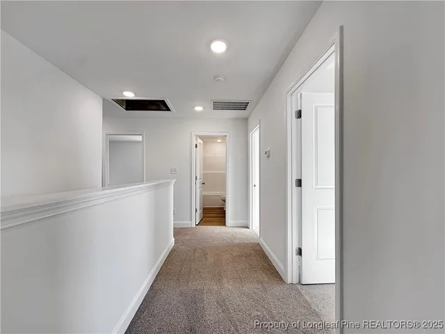 a bathroom with a granite countertop sink a toilet a mirror and bathtub