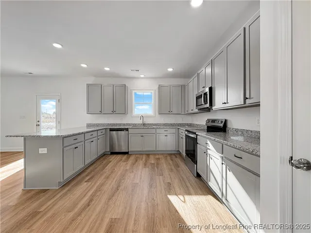 a large kitchen with a white stove top oven sink and cabinets