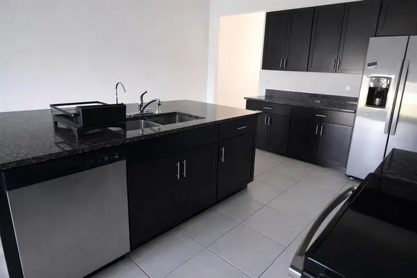 a kitchen with a sink and a refrigerator