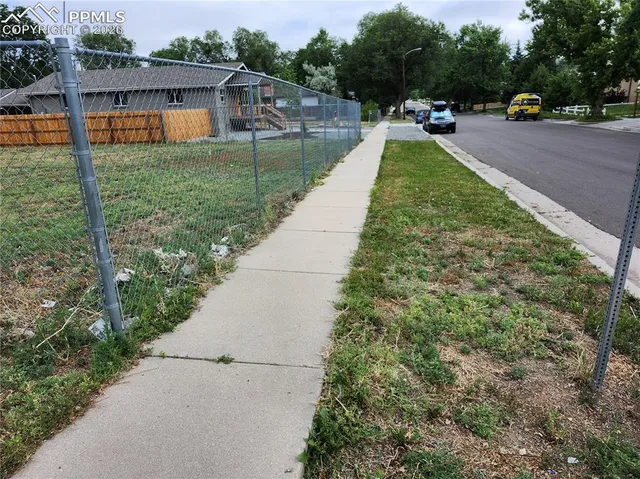 a view of a backyard with swimming pool