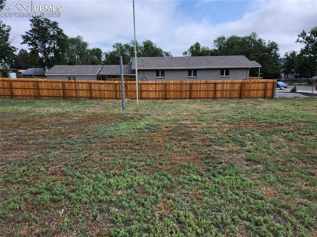 1504 Tweed Street Colorado Springs, CO 80909 - Photo 6 of 6 a view of a house with a yard