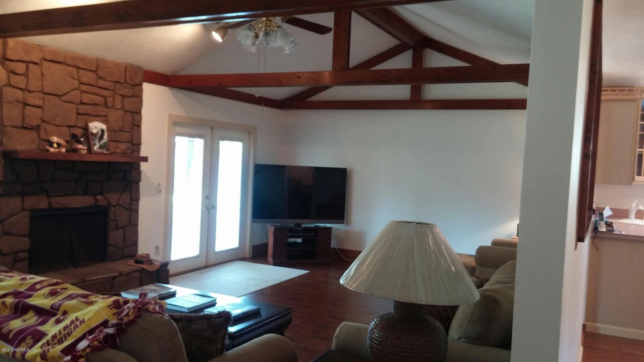 10823 Reading Road Jacksonville, FL 32257 - Photo 21 of 21 a living room with furniture and a fireplace