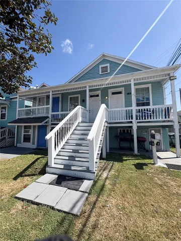 a view of a house with wooden floor and a yard