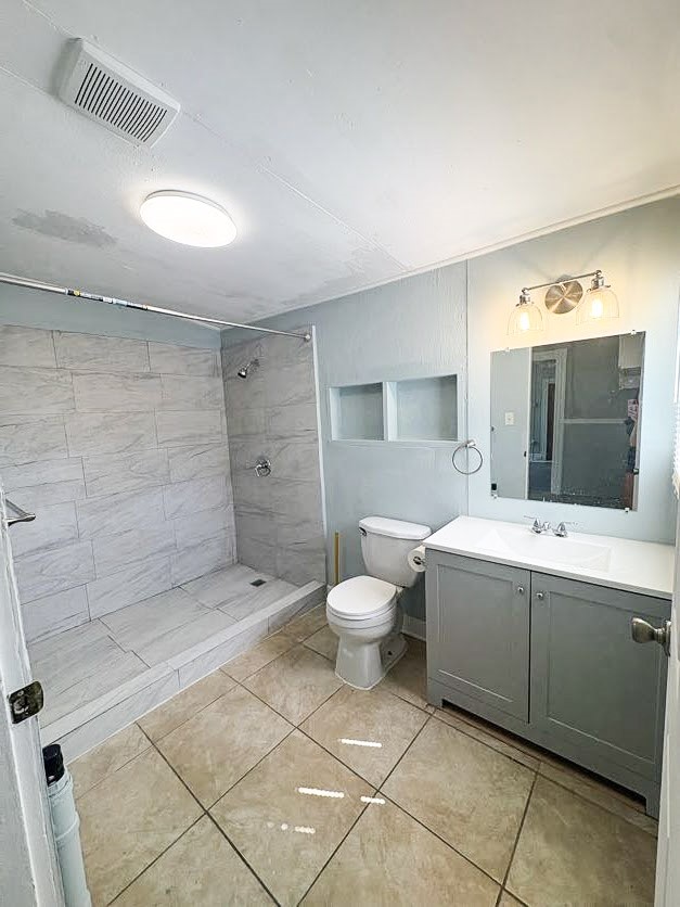 1810 24th Street Rear, Unit 3 Galveston, TX 77550 - Photo 7 of 8 a bathroom with a toilet sink and mirror