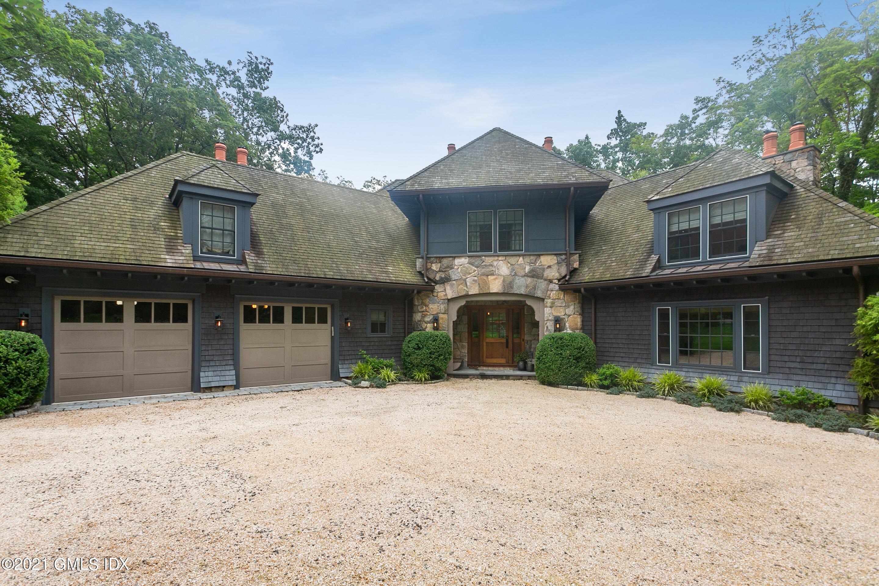 a front view of a house with a yard and a garage