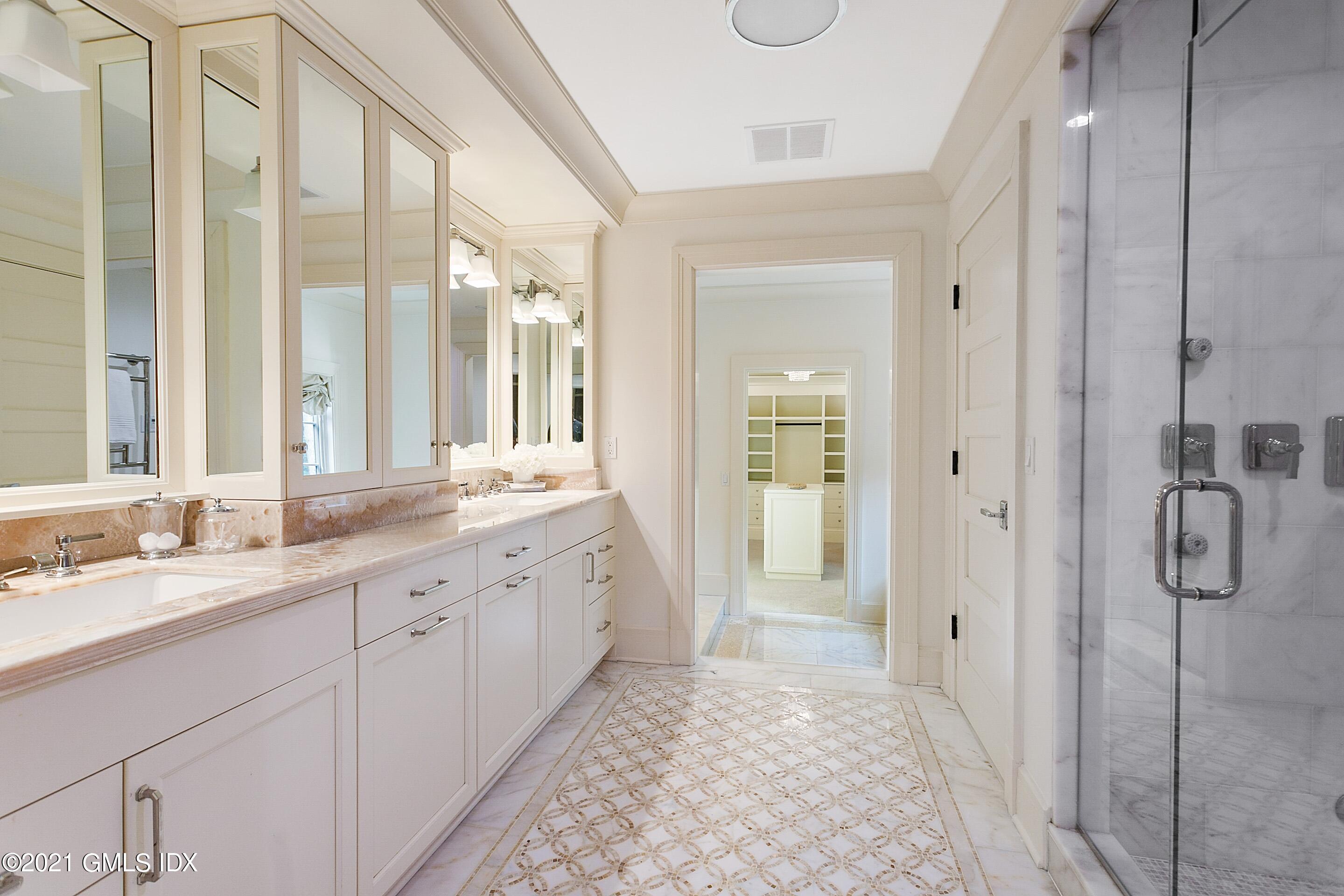 125 Cat Rock Road Cos Cob, CT 06807 - Photo 18 of 45 a spacious bathroom with a double vanity sink mirror and shower