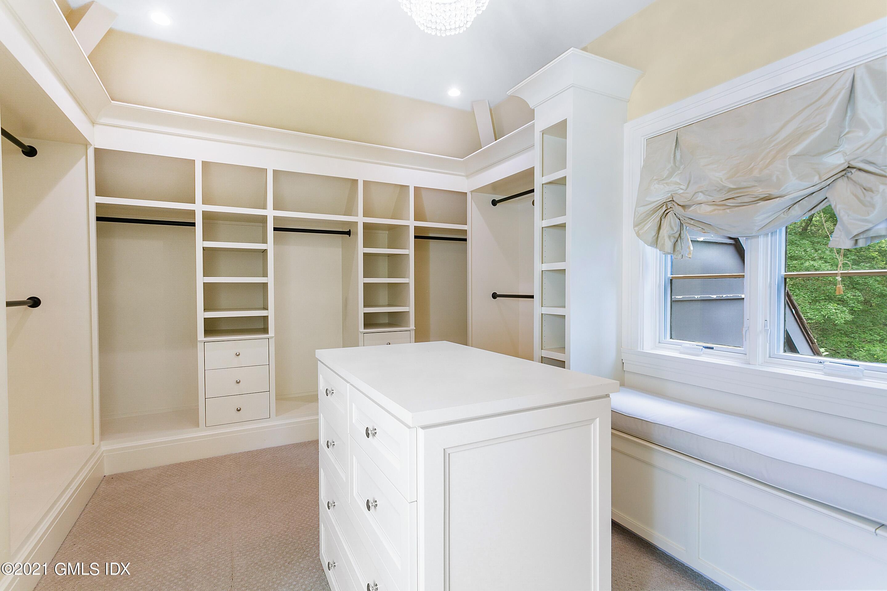 125 Cat Rock Road Cos Cob, CT 06807 - Photo 20 of 45 a view of walk in closet with clothes and shoes