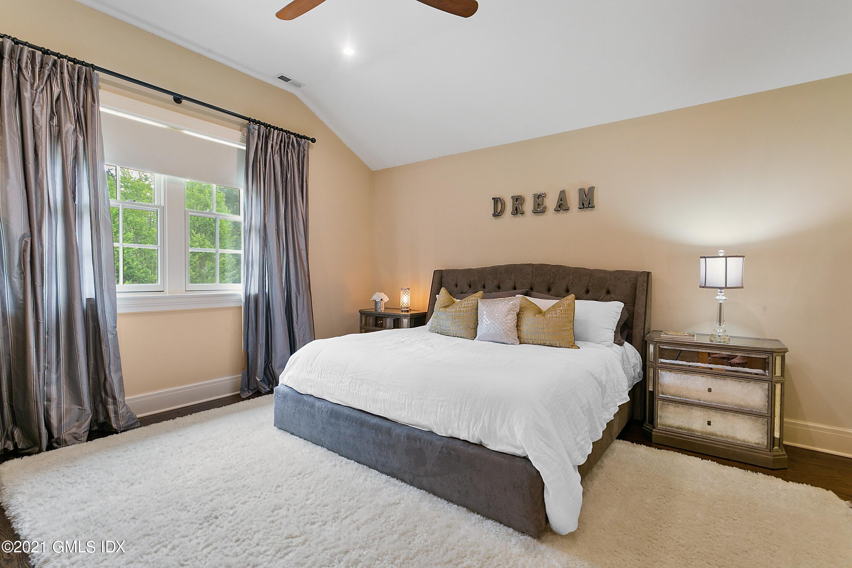 125 Cat Rock Road Cos Cob, CT 06807 - Photo 23 of 45 a bedroom with a bed and a night stand