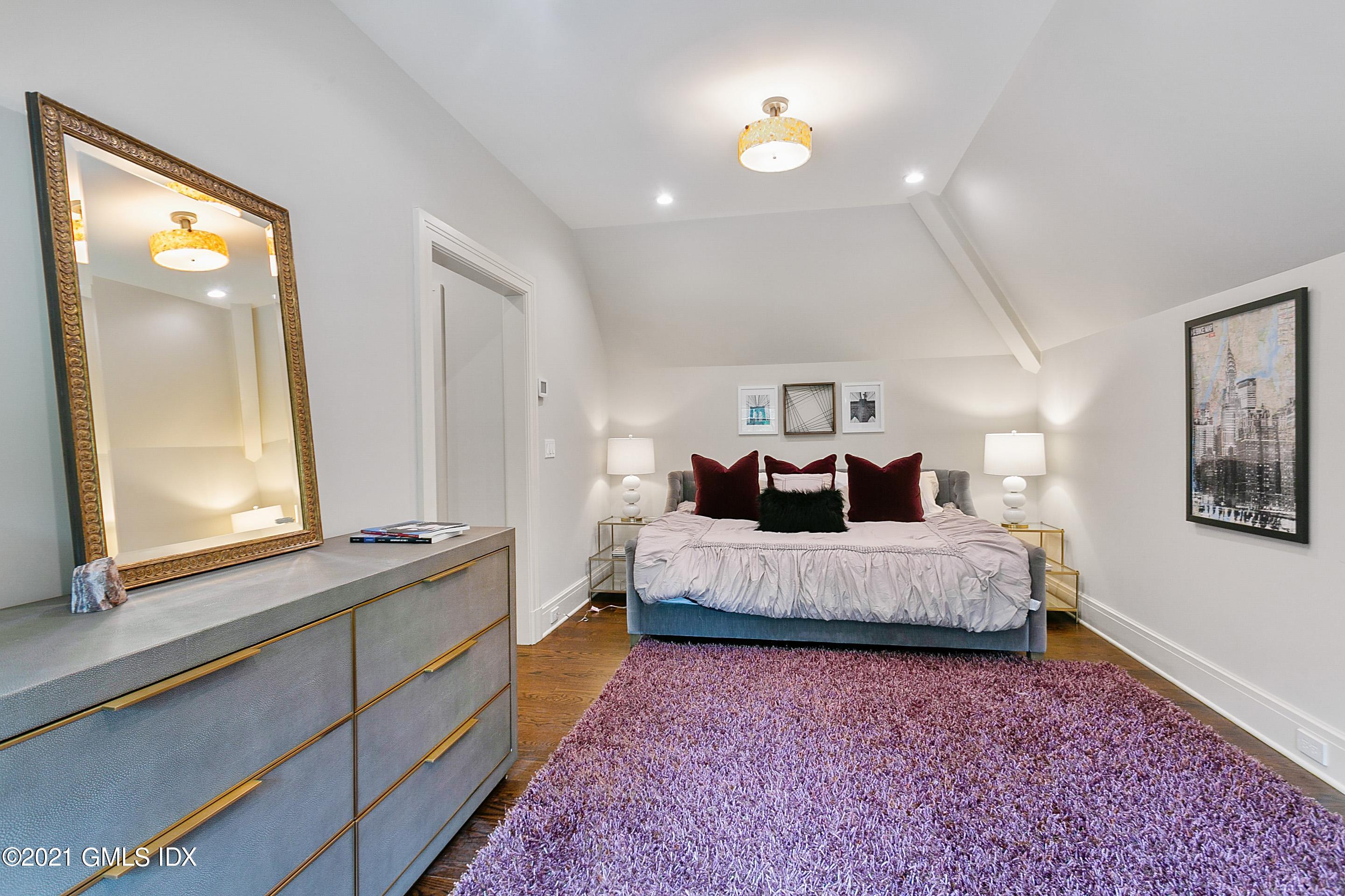 125 Cat Rock Road Cos Cob, CT 06807 - Photo 25 of 45 a spacious bedroom with a bed and a window