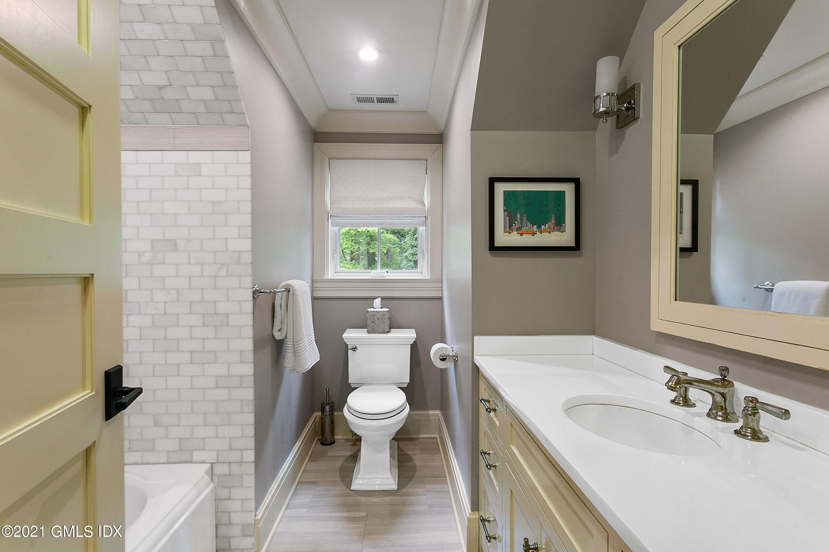125 Cat Rock Road Cos Cob, CT 06807 - Photo 26 of 45 a bathroom with a toilet sink and mirror