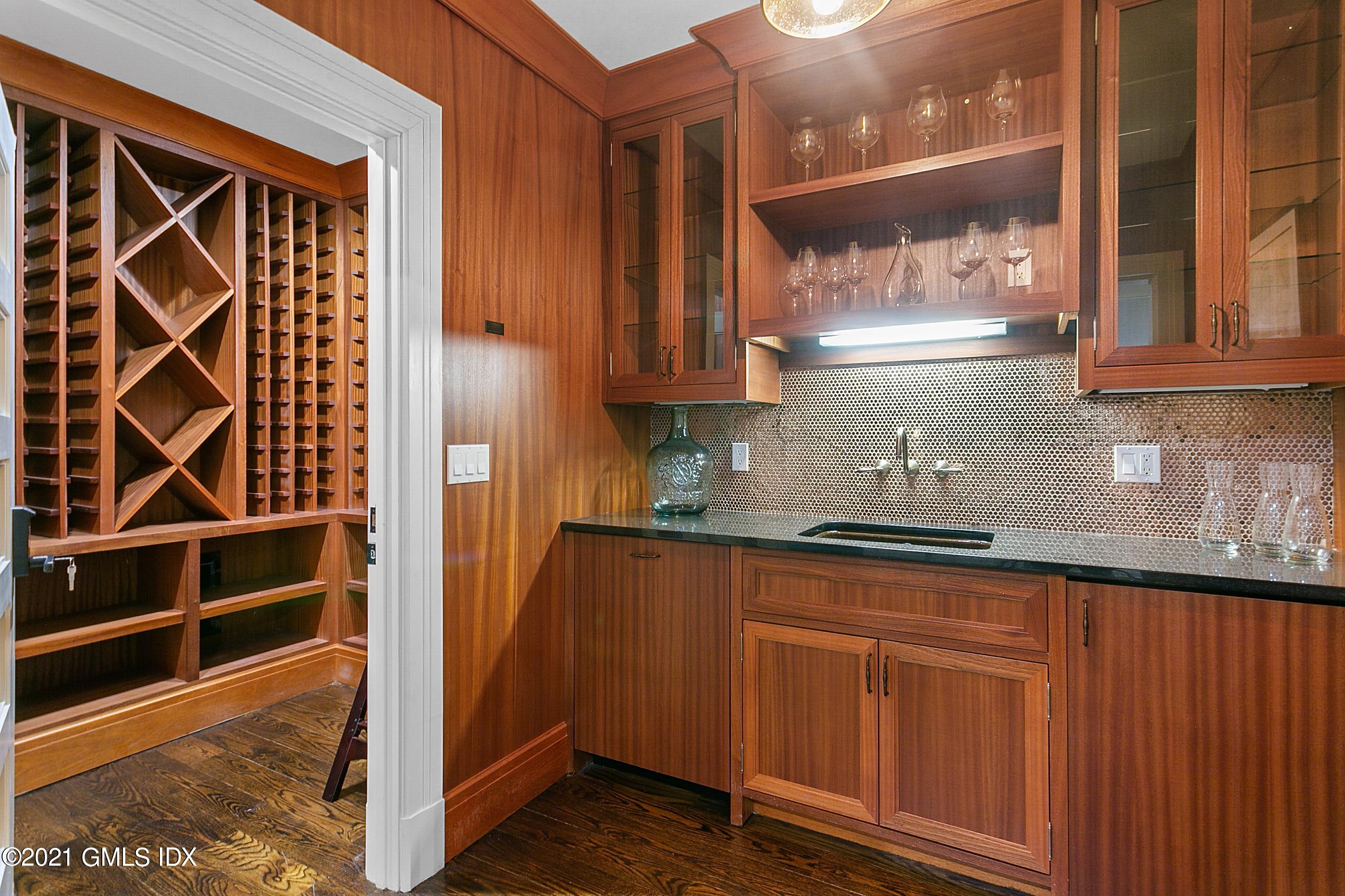 125 Cat Rock Road Cos Cob, CT 06807 - Photo 30 of 45 a kitchen with granite countertop wooden cabinets and a sink