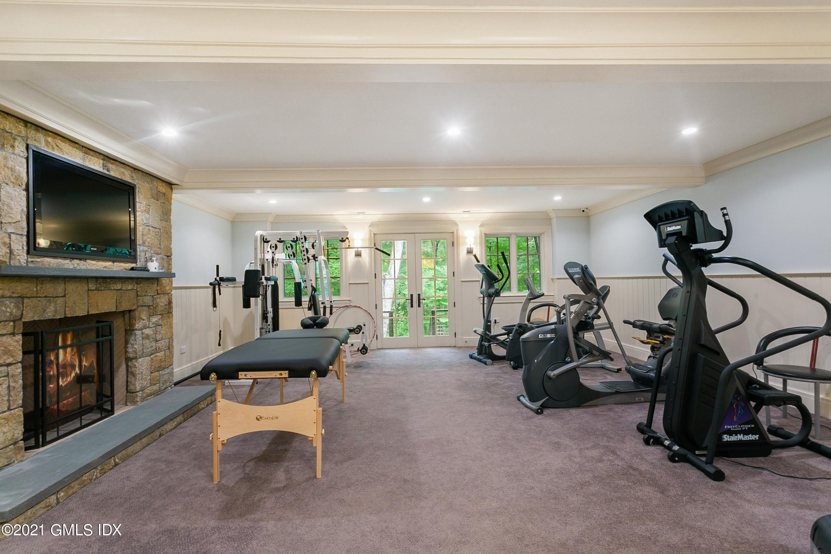 125 Cat Rock Road Cos Cob, CT 06807 - Photo 31 of 45 a living room with furniture a fireplace and a flat screen tv