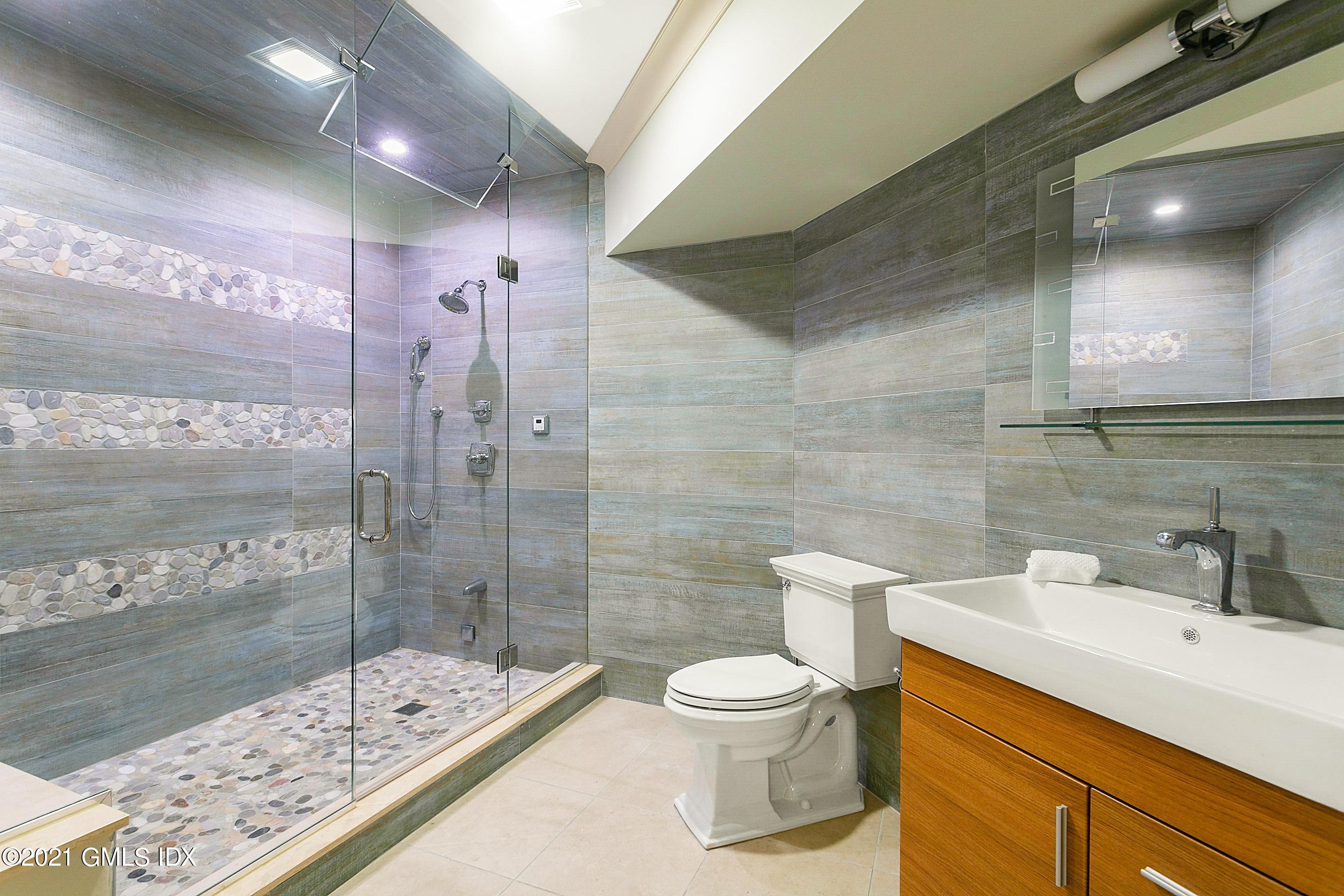 125 Cat Rock Road Cos Cob, CT 06807 - Photo 33 of 45 a bathroom with a sink a toilet and shower