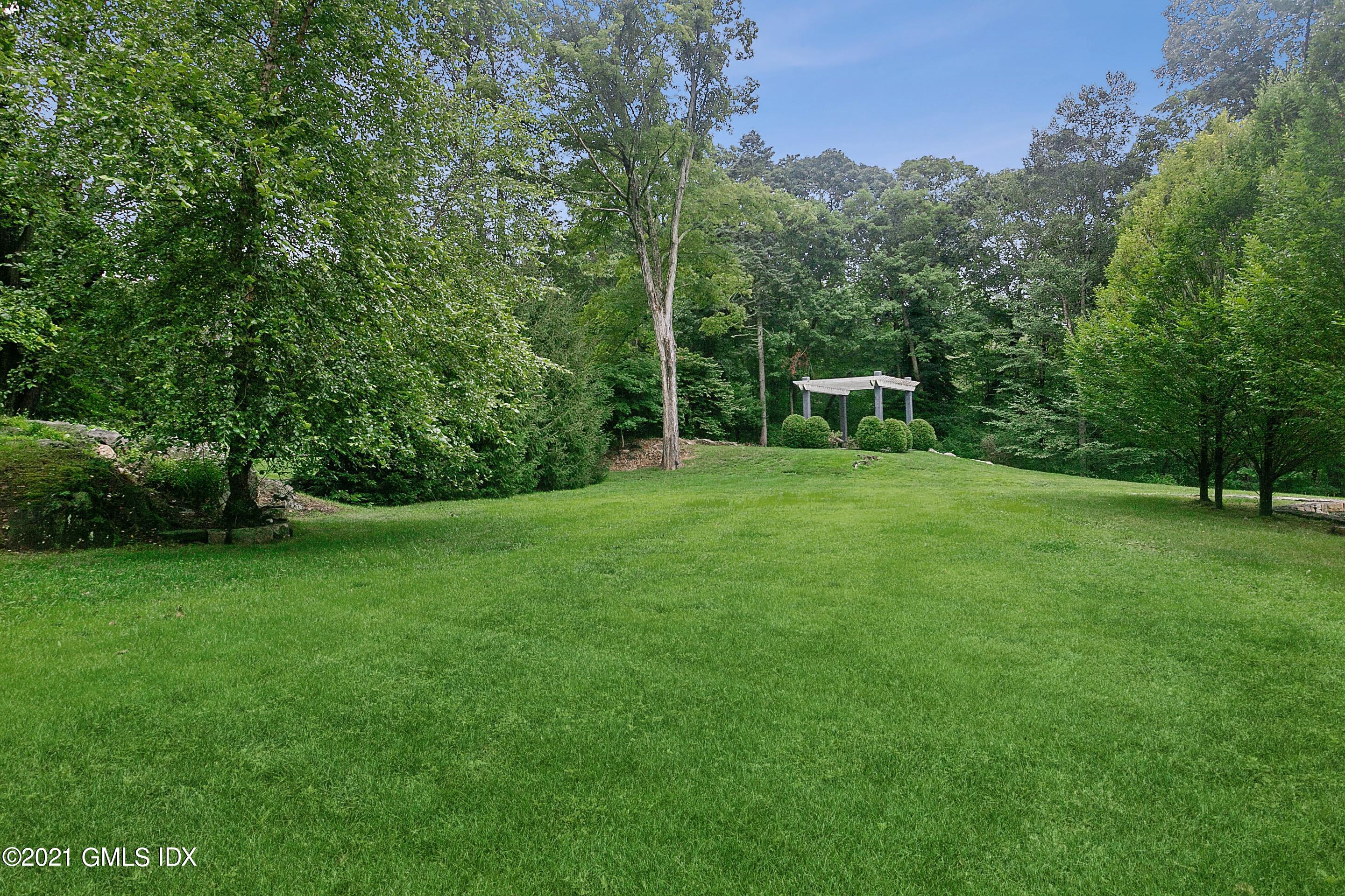 125 Cat Rock Road Cos Cob, CT 06807 - Photo 38 of 45 a view of a house with a backyard