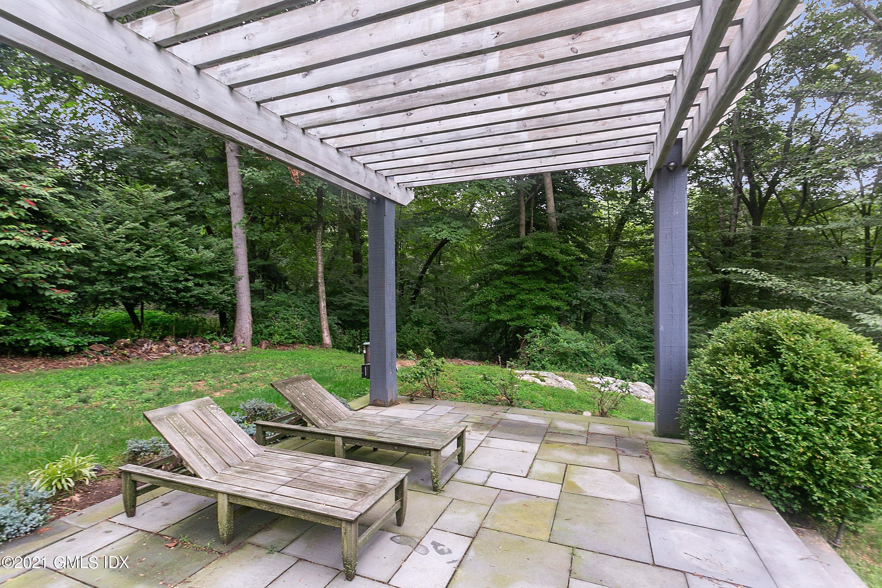 125 Cat Rock Road Cos Cob, CT 06807 - Photo 39 of 45 a view of a patio with a table chairs and a backyard