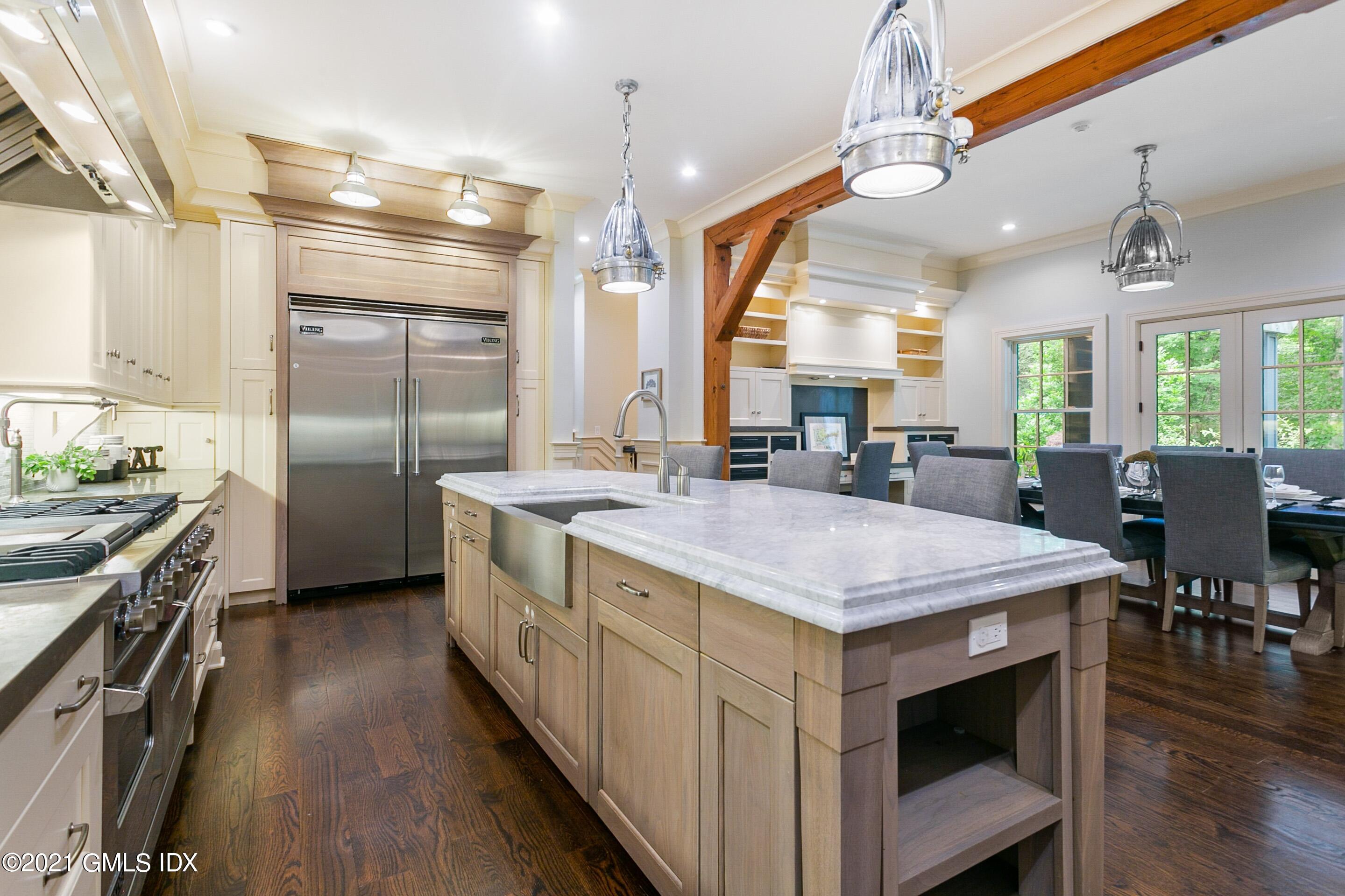 125 Cat Rock Road Cos Cob, CT 06807 - Photo 4 of 45 a kitchen with kitchen island a counter top space a sink stainless steel appliances and cabinets