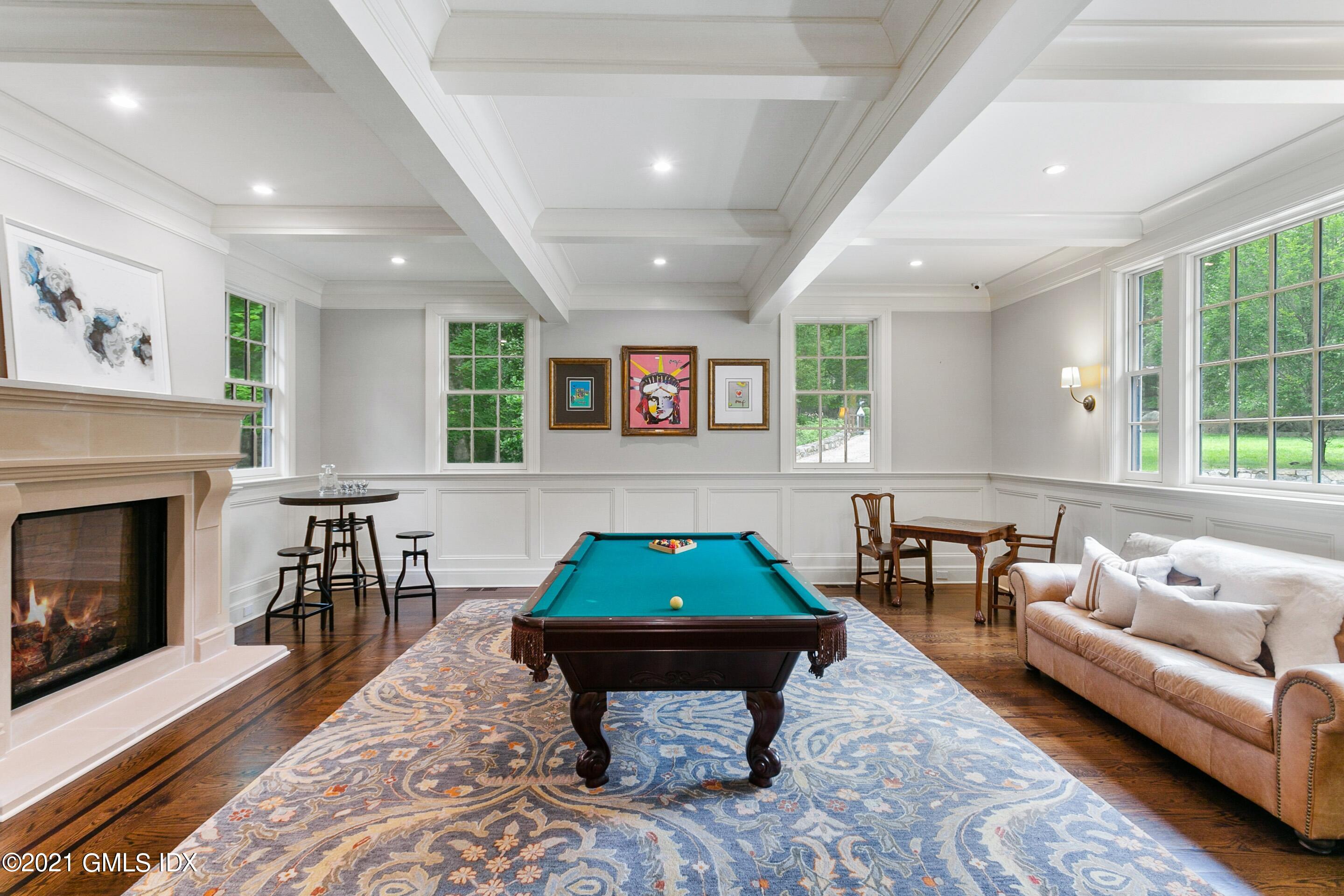 125 Cat Rock Road Cos Cob, CT 06807 - Photo 9 of 45 a living room with furniture a pool table and a fireplace