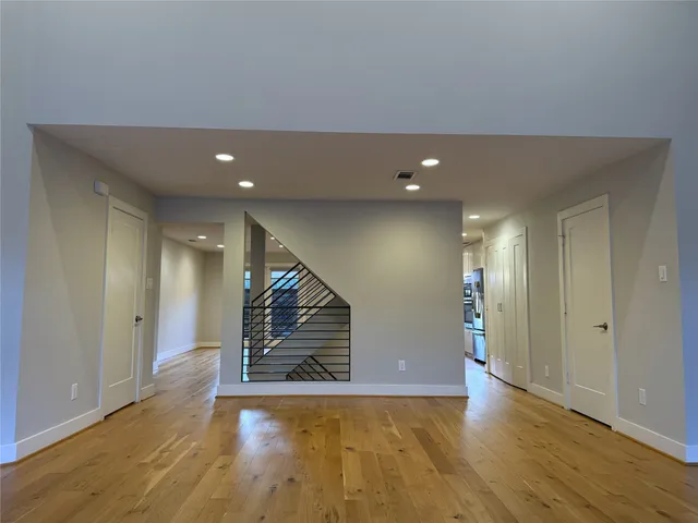 a view of an empty room with wooden floor