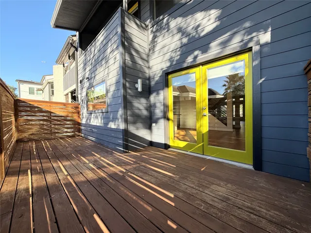 a large kitchen with stainless steel appliances a large counter top a stove a sink and a refrigerator