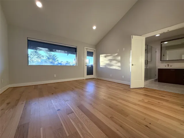 a bathroom with a double vanity sink mirror and bathtub