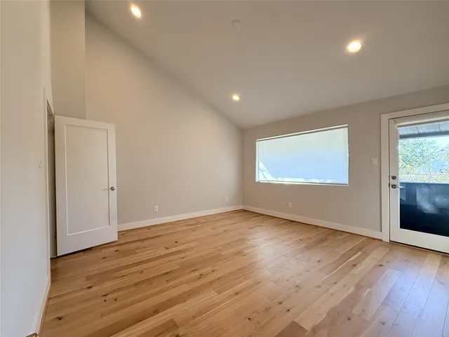 a view of a patio with table and chairs with wooden floor and fence