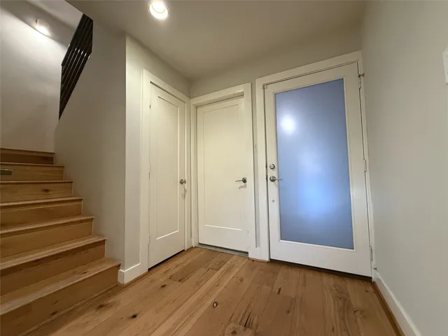 a view of an entryway with wooden floor