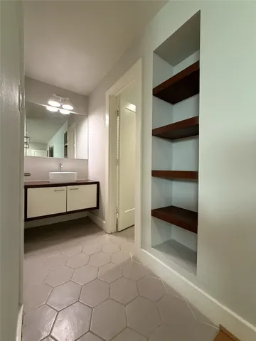 a view of a room with a large window and furniture