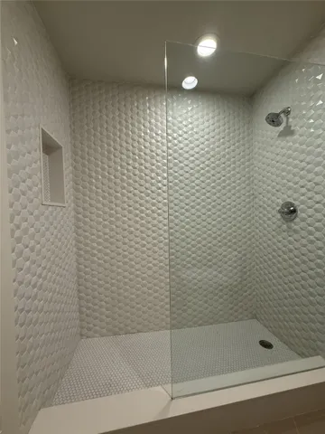 a bathroom with a shower and a bathtub