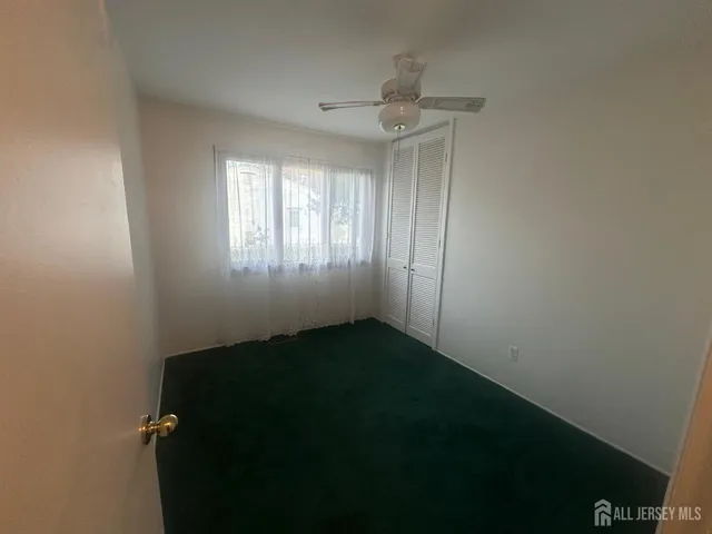 a view of an empty room and a window