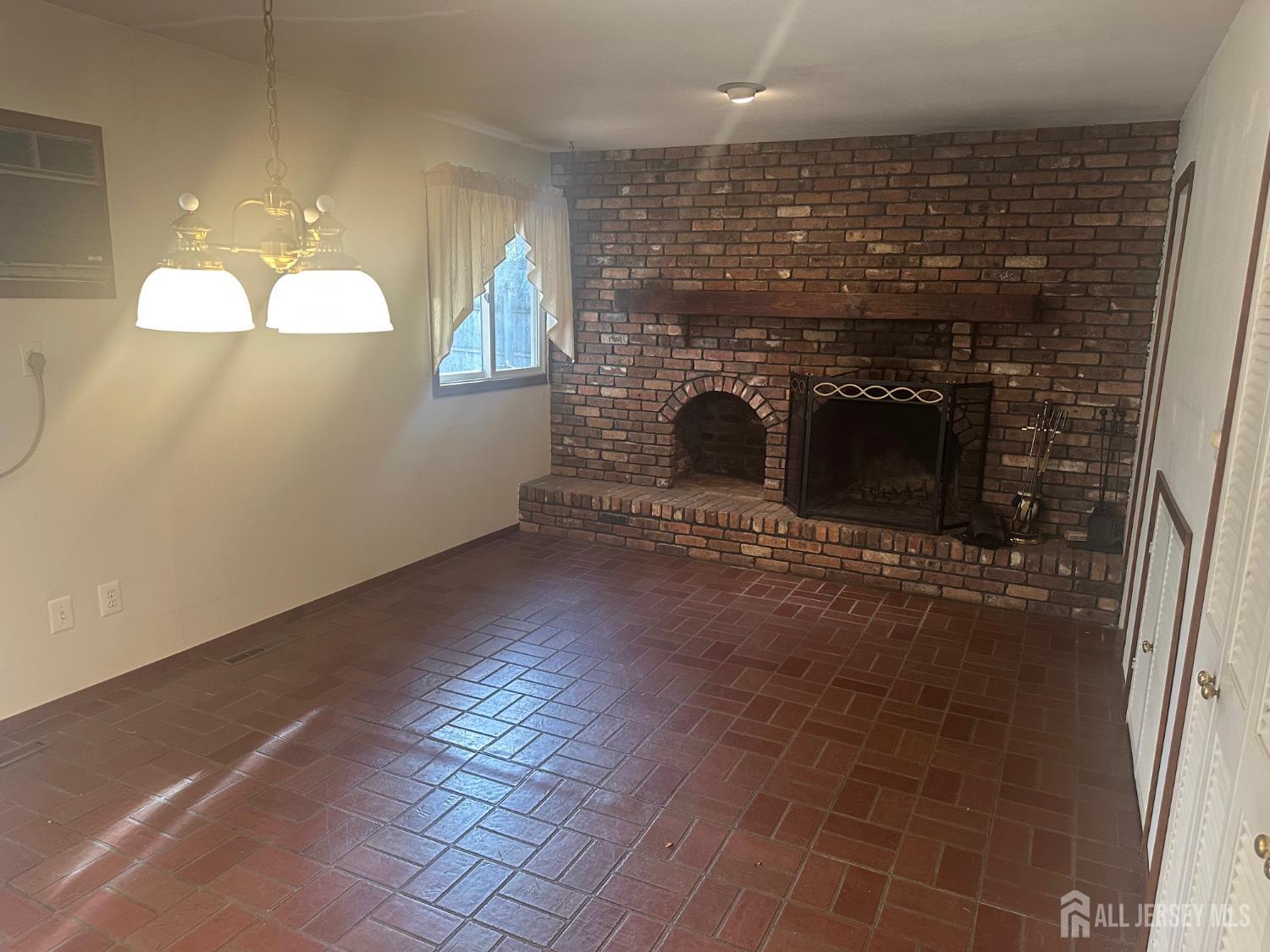 22 Richford Road Kendall Park, NJ 08824 - Photo 6 of 23 a view of empty room with wooden floor and fireplace