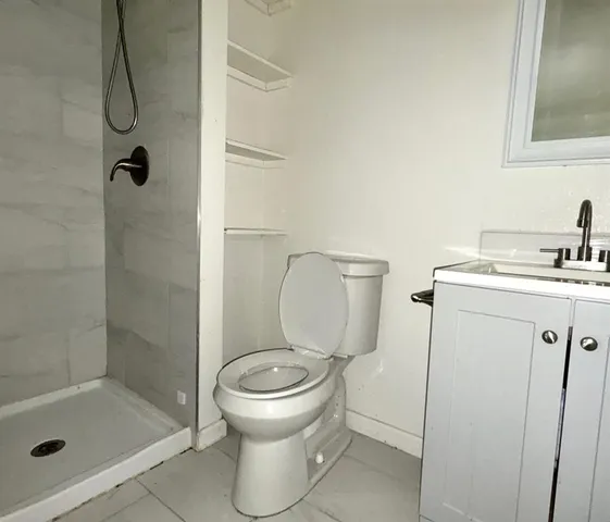 a bathroom with a sink toilet and shower