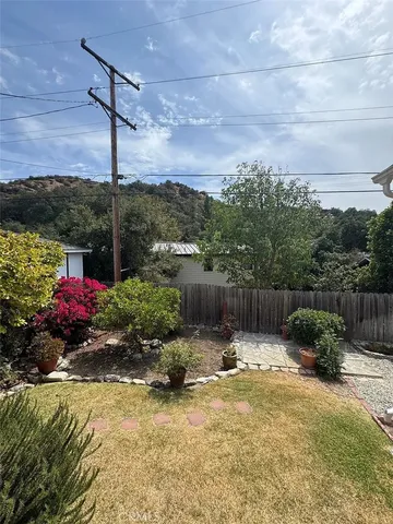 a view of a backyard with sitting area
