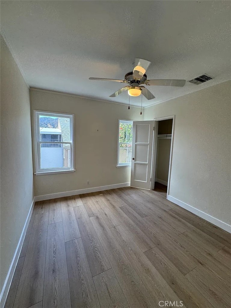 1852 Alpha Road Glendale, CA 91208 - Photo 19 of 29 a view of an empty room with a window and wooden floor