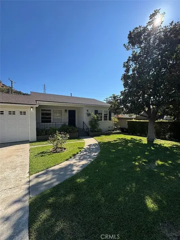 a front view of a house with garden and porch