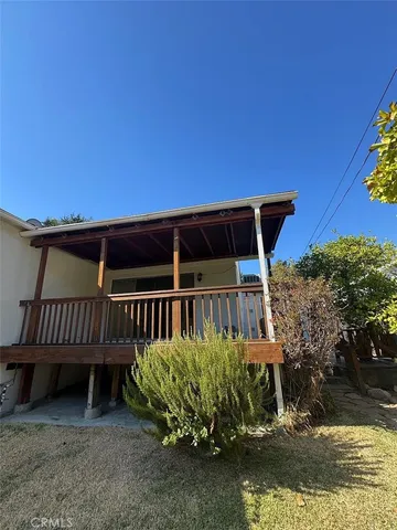 a view of a roof deck with chair and table