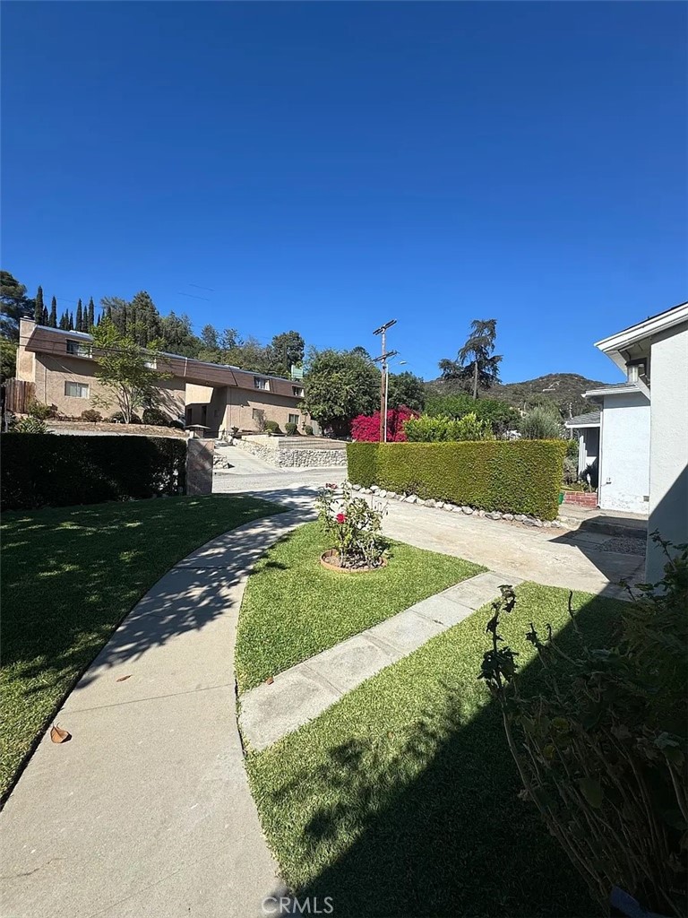 1852 Alpha Road Glendale, CA 91208 - Photo 28 of 29 a view of a pathway both side of grassy field with shrub
