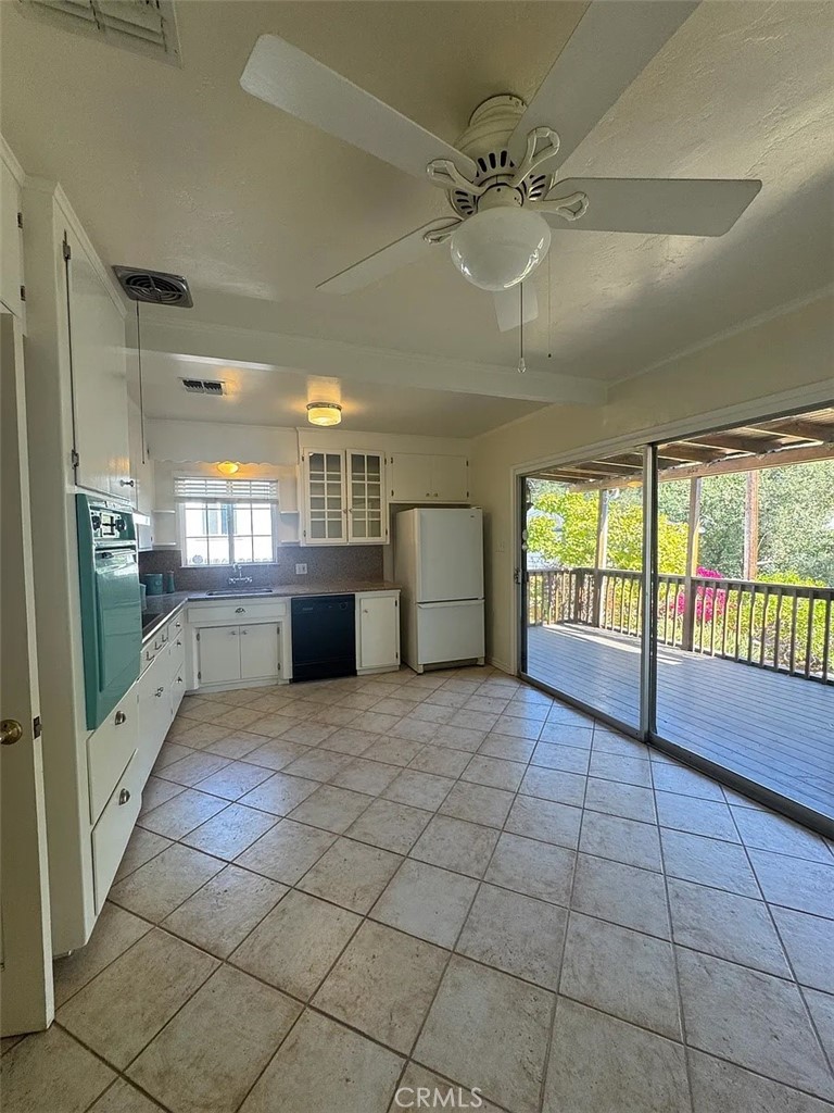 1852 Alpha Road Glendale, CA 91208 - Photo 9 of 29 a large white kitchen with a large window and refrigerator