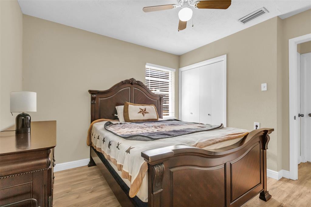 2311 Arcady Lane Lancaster, TX 75134 - Photo 14 of 22 a bedroom with a bed and a chandelier