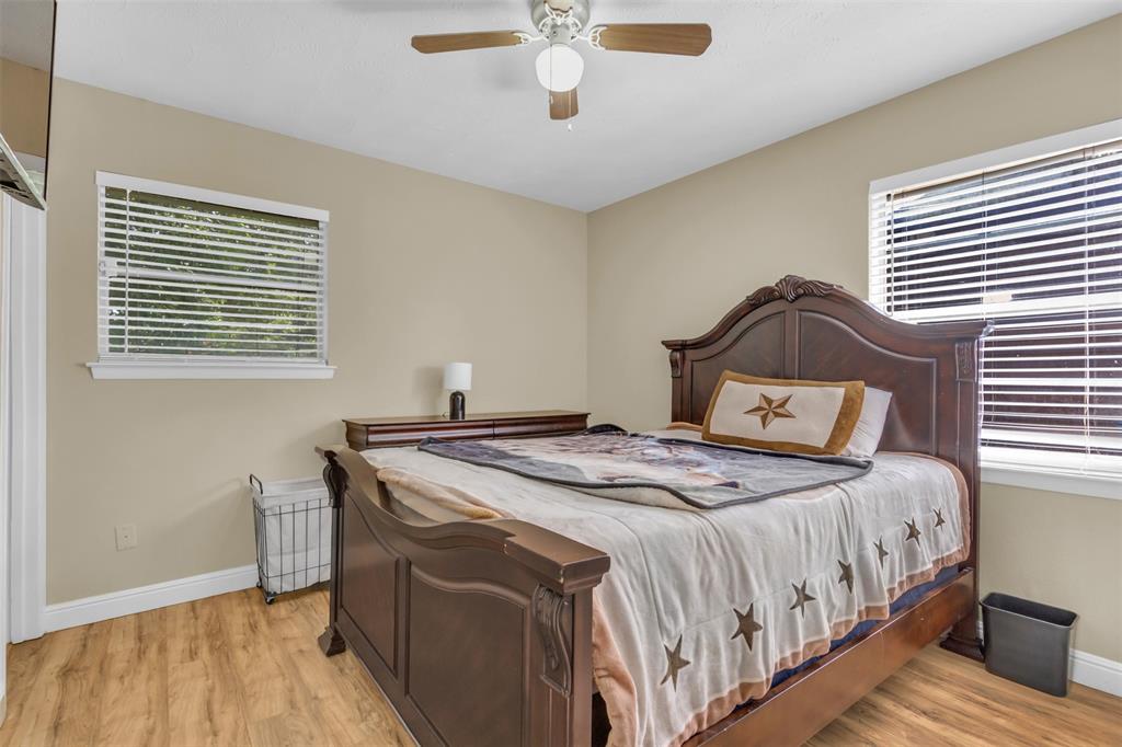 2311 Arcady Lane Lancaster, TX 75134 - Photo 16 of 22 a bedroom with a bed and a chandelier