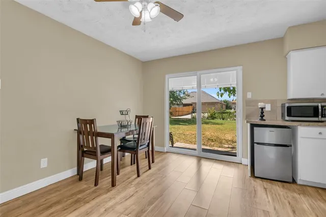a view of a dining room with furniture window and wooden floor