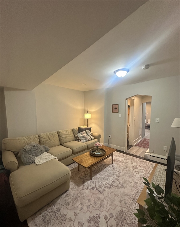 847 Beacon Street, Unit 9 Boston, MA 02215 - Photo 4 of 10 a living room with furniture a couch and dresser