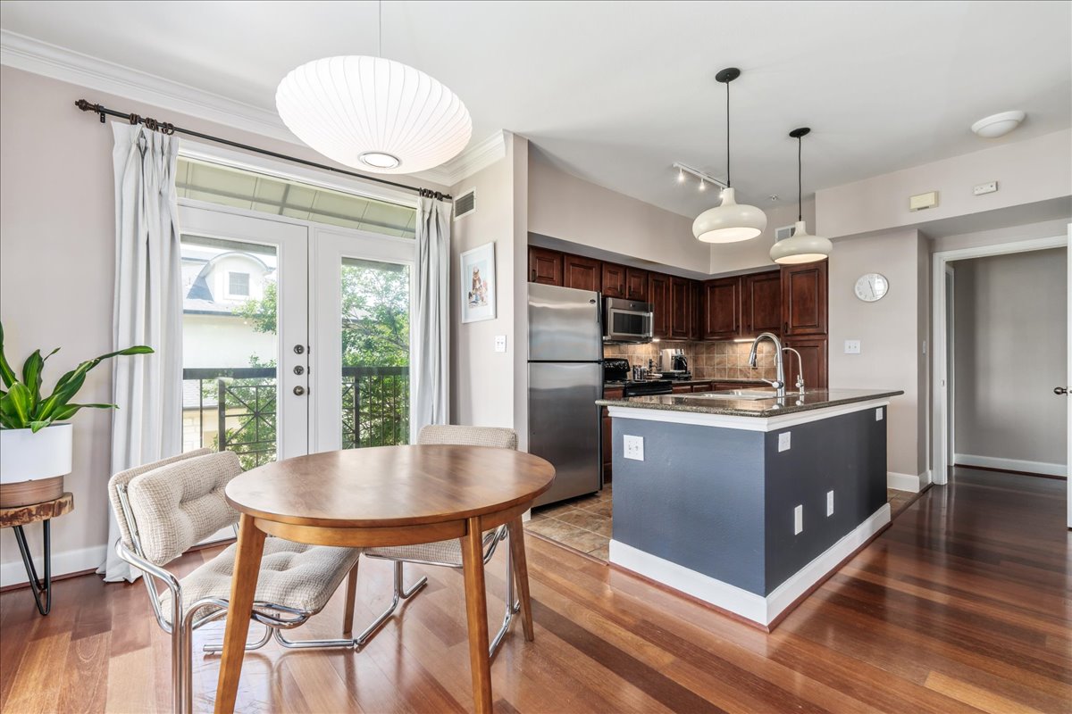 7701 Rialto Boulevard, Unit 91 Austin, TX 78735 - Photo 13 of 39 a kitchen with a table and chairs in it