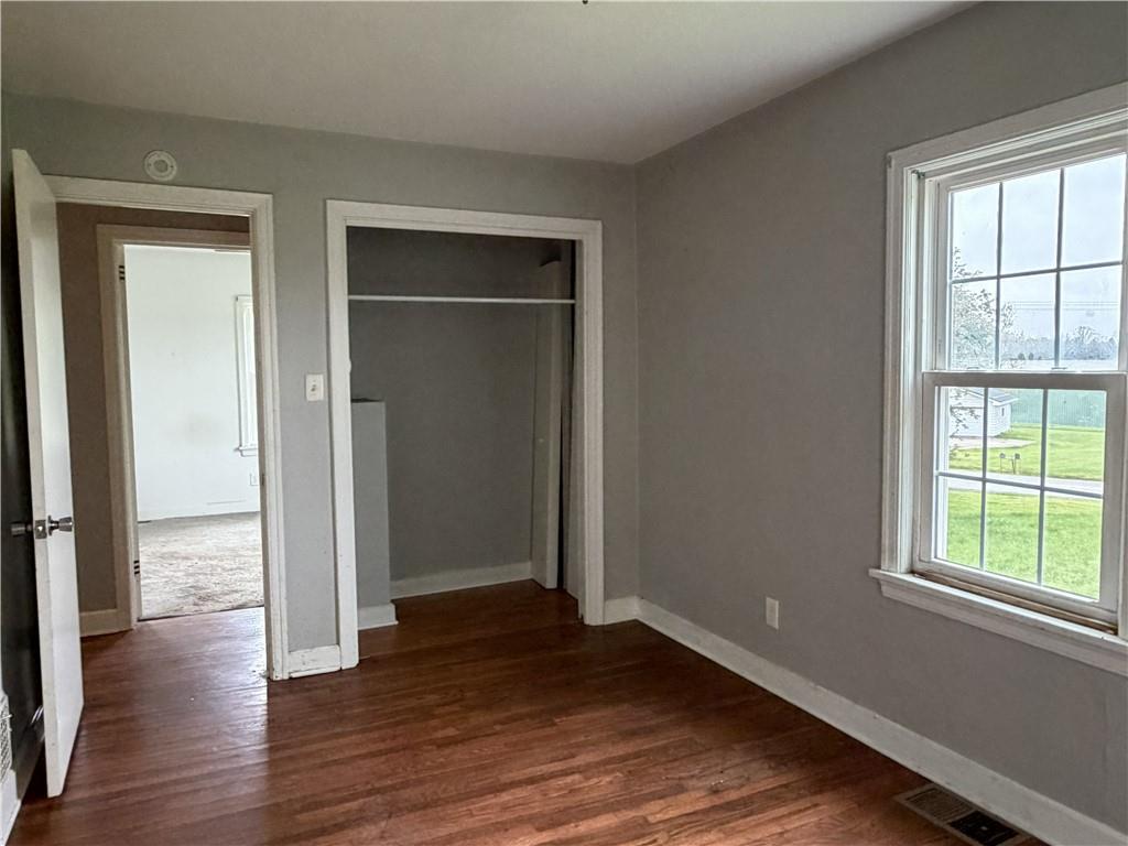 1146 Franklin Road Jackson Center, PA 16133 - Photo 15 of 19 an empty room with wooden floor closet and windows