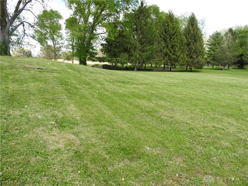 2105 East Loy Road Piqua, OH 45356 - Photo 4 of 26 Expansive green yard with mature trees offers a serene natural setting.