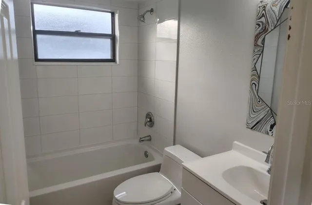 en empty room with a mirror and shower